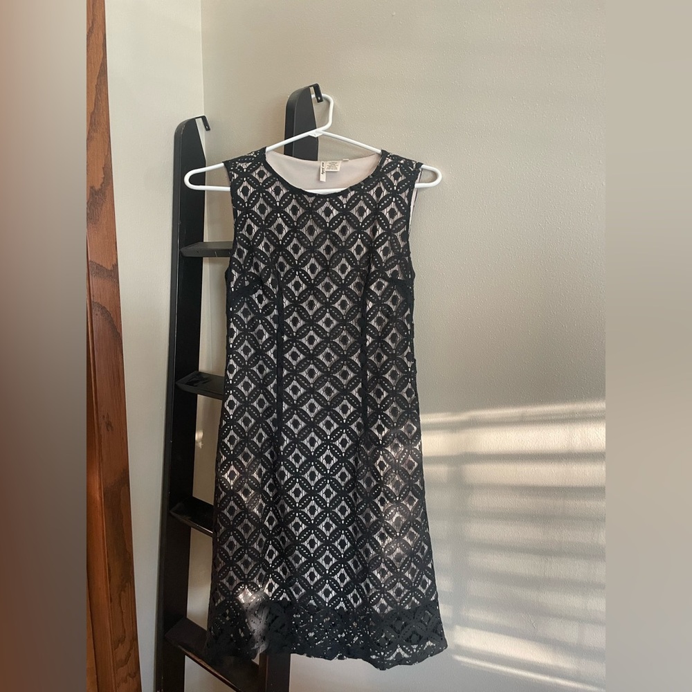 Black lace short dress worn tan shift dress underneath
